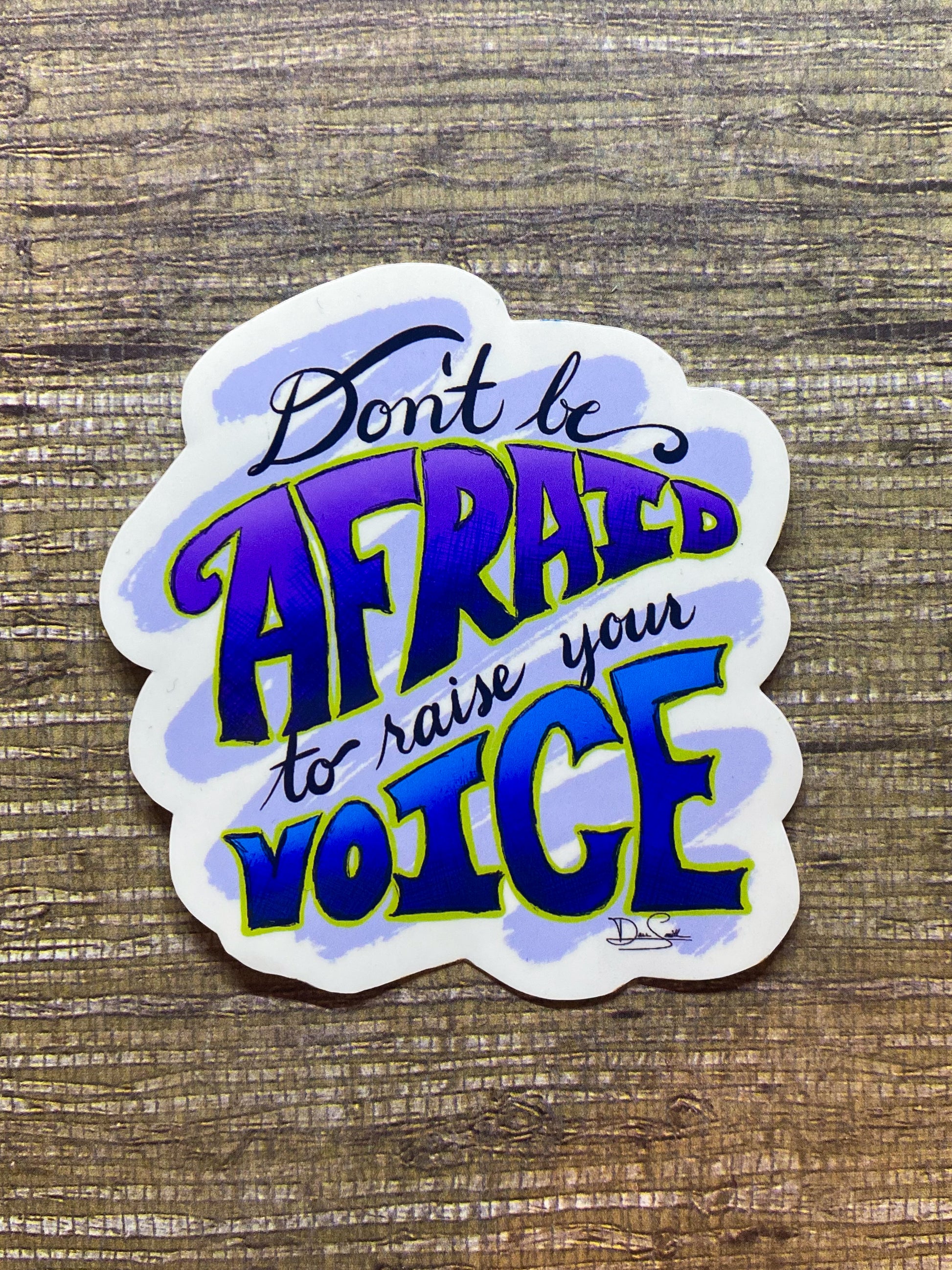 Don't be Afraid to raise your Voice sticker in purple and blue font with a lime green outline.