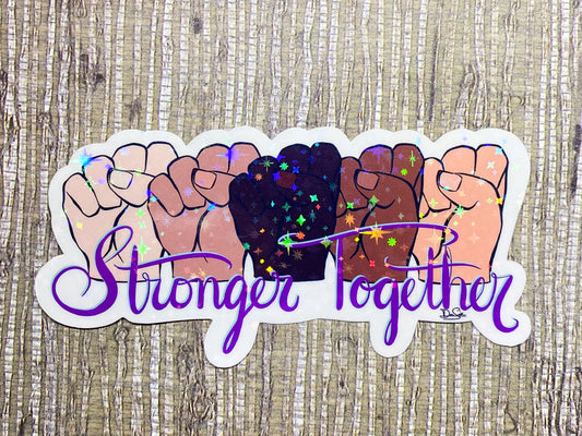 Image shows a sticker featuring five fists in various skin tones above the words Stronger Together in purple, cursive font 